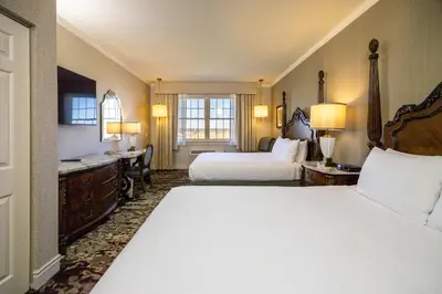 a hotel room with two beds and a desk at AmishView Inn & Suites in Bird in Hand