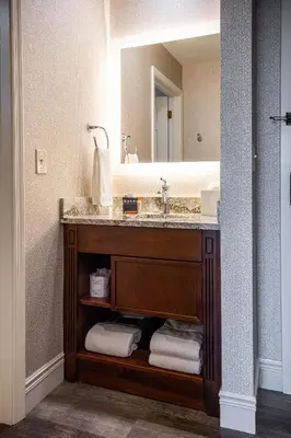 a bathroom with a sink and a mirror at AmishView Inn & Suites in Bird in Hand