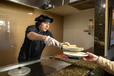 a chef preparing food in a restaurant kitchen at AmishView Inn & Suites in Bird in Hand