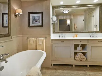a bathroom with a tub and a sink and a mirror at AmishView Inn & Suites in Bird in Hand
