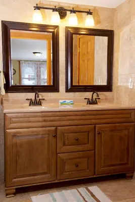 a bathroom with two sinks and a large mirror at Myer Country Motel in Milford