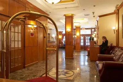 a woman is sitting in a lobby at Hotel St. James in New York