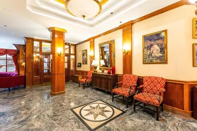 a lobby with chairs and a desk and a mirror at Hotel St. James in New York