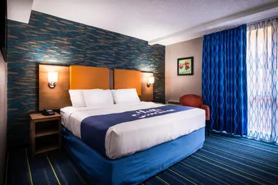 a hotel room with a large bed in a room at Days Inn by Wyndham Wayne in Wayne
