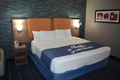a large bed in a hotel room with a king size bed at Days Inn by Wyndham Wayne in Wayne