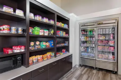 a kitchen with two refrigerators with food and drinks at La Quinta by Wyndham Clifton/Rutherford in Clifton