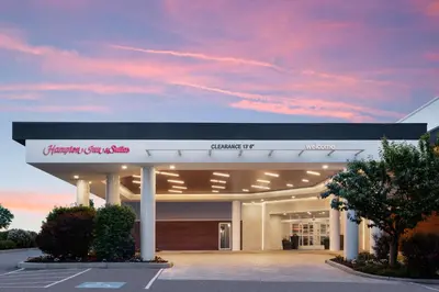 a shopping center with a building with a sunset at Hampton Inn & Suites Hershey in Hershey
