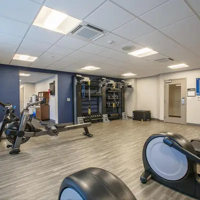 a gym with treadmills and ellipticals in a room at Hampton Inn Harrisburg-East/Hershey in Harrisburg