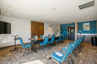 a conference room with a table and blue chairs at Hampton Inn Harrisburg-East/Hershey in Harrisburg