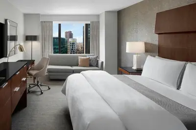 a hotel room with a bed and a couch at The Westin New York Grand Central in New York