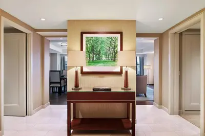 a lobby with a desk and a painting on the wall at The Westin New York Grand Central in New York