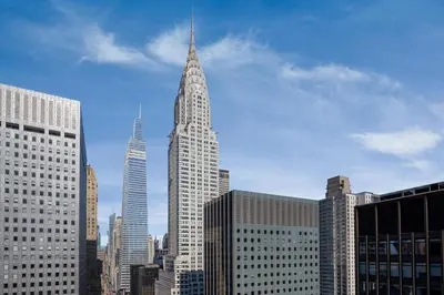 a tall building with a spire in a city at The Westin New York Grand Central in New York
