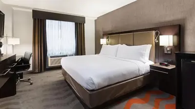 a hotel room with a large bed and a desk at Holiday Inn Lower East Side by IHG in New York
