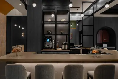 a restaurant with a bar with chairs and a counter at Courtyard by Marriott New York World Trade Center Area in New York