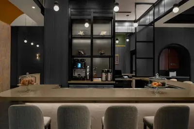 a restaurant with a bar with chairs and a counter at Courtyard by Marriott New York World Trade Center Area in New York