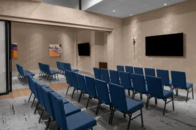 a conference room with blue chairs and a table at Courtyard by Marriott New York World Trade Center Area in New York