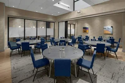 a conference room with tables and blue chairs at Courtyard by Marriott New York World Trade Center Area in New York