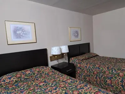 a hotel room with two beds next to each other at Pennswoods Inn in Manheim