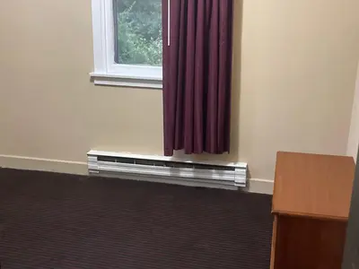 a room with a window with a red curtain at Pennswoods Inn in Manheim