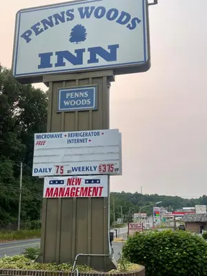 a sign for a firm with signs on a street at Pennswoods Inn in Manheim