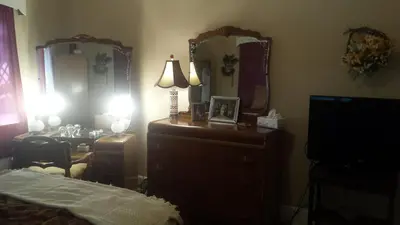 a bedroom with a dresser and two large mirrors at Maurrocks - A Pocono Mountains B&B in Mount Pocono