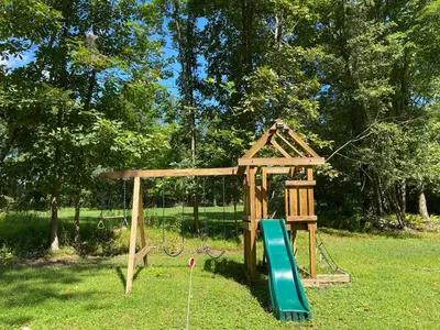 a playground in a park with a swing at Secluded Greekside Cabin near Camelback in Tannersville