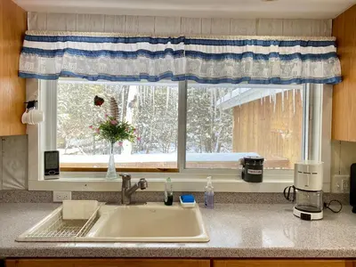 a kitchen counter with a sink and a window at Secluded Greekside Cabin near Camelback in Tannersville