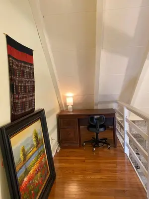 an attic room with a desk and a painting at Secluded Greekside Cabin near Camelback in Tannersville