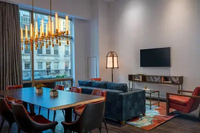 a living room with a table and a couch at Renaissance New York Chelsea Hotel in New York