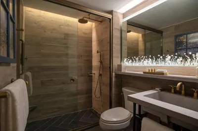 a bathroom with a shower and a toilet and a sink at Renaissance New York Chelsea Hotel in New York
