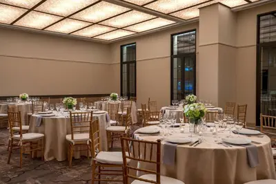 a banquet hall with tables and chairs with flowers on them at Renaissance New York Chelsea Hotel in New York