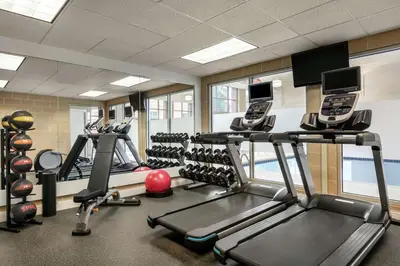 a gym with several treadmills and cardio machines at Homewood Suites by Hilton Harrisburg East-Hershey Area in Harrisburg