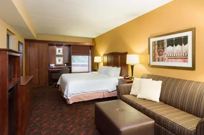 a hotel room with a bed and a couch at Larkspur Landing Carlisle in Carlisle