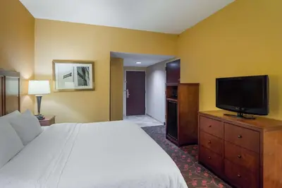a hotel room with a bed and a flat screen tv at Larkspur Landing Carlisle in Carlisle