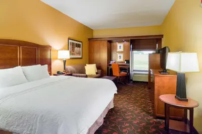 a hotel room with a large bed and a desk at Larkspur Landing Carlisle in Carlisle