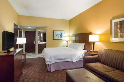 a hotel room with a bed and a couch at Larkspur Landing Carlisle in Carlisle