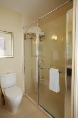 a bathroom with a toilet and a glass shower at Hilton Garden Inn Lancaster in Lancaster