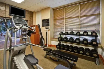 a gym with a treadmill and a tv in a room at Homewood Suites by Hilton Lancaster in Lancaster