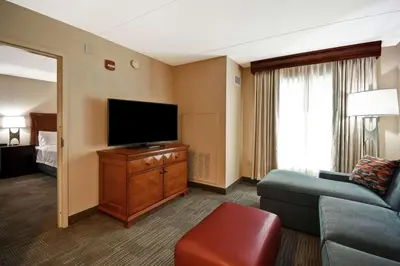 a living room with a couch and a flat screen tv at Homewood Suites by Hilton Lancaster in Lancaster