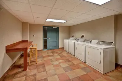 a row of washers and dryers in a room at Homewood Suites by Hilton Lancaster in Lancaster