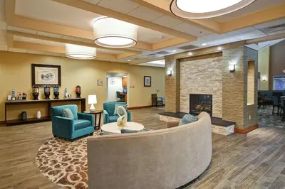 a lobby with a couch and chairs and a fireplace at Homewood Suites by Hilton Lancaster in Lancaster