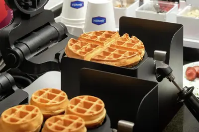 a waffle maker with waffles on top of it at Hampton Inn Lancaster in Lancaster