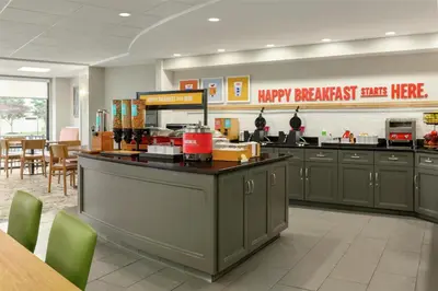a fast food restaurant with a happy breakfast here counter at Hampton Inn Lancaster in Lancaster