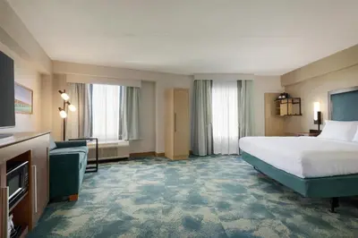 a hotel room with a bed and a couch at Hampton Inn Lancaster in Lancaster
