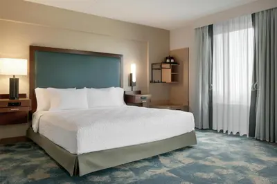 a hotel room with a bed and a large window at Hampton Inn Lancaster in Lancaster