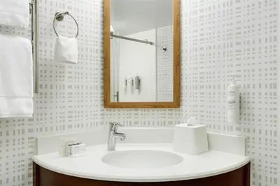 a bathroom with a sink and a mirror at Hampton Inn Lancaster in Lancaster