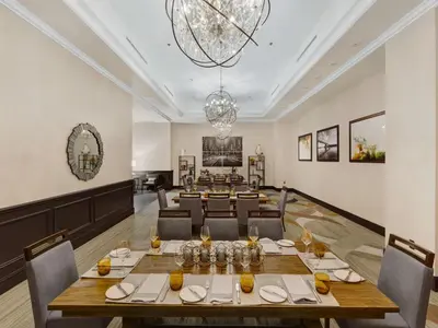 a large dining room with a long table and chairs at Hilton Harrisburg near Hershey Park in Harrisburg