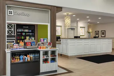 a store lobby with a counter with drinks and a counter sidx sidx sidx at Hilton Garden Inn Harrisburg East in Harrisburg