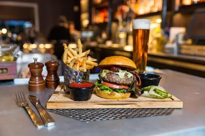 a hamburger and french fries and a glass of beer at Hilton Wilmington/Christiana in Newark