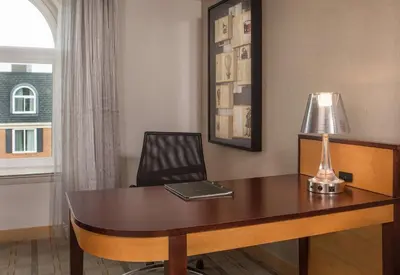 a desk with a lamp and a laptop on it at Hilton Wilmington/Christiana in Newark